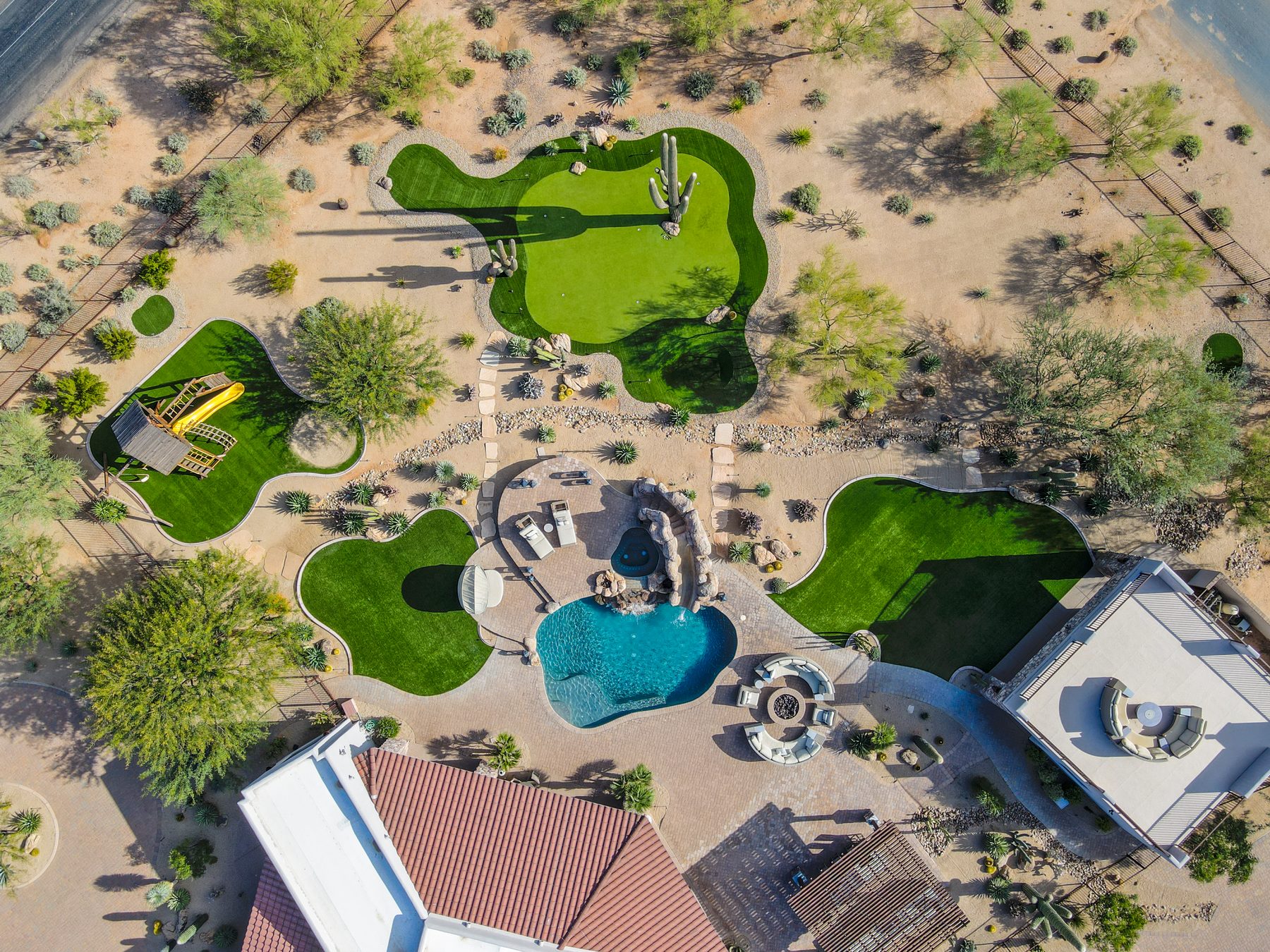 Top-down aerial view of the desert estate showing pool, putting green, and outdoor living areas