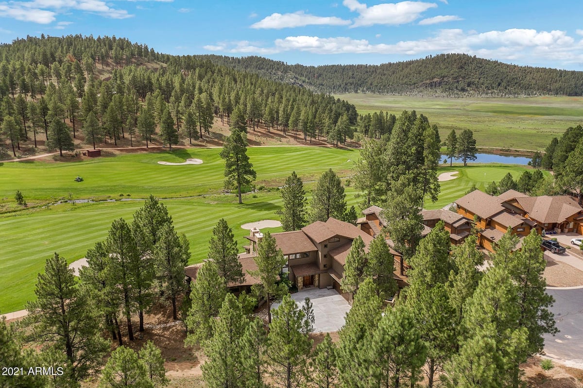 Breakthrough Lodge — mountain lodge with stone fireplace and forest views inside Flagstaff Ranch Golf Community